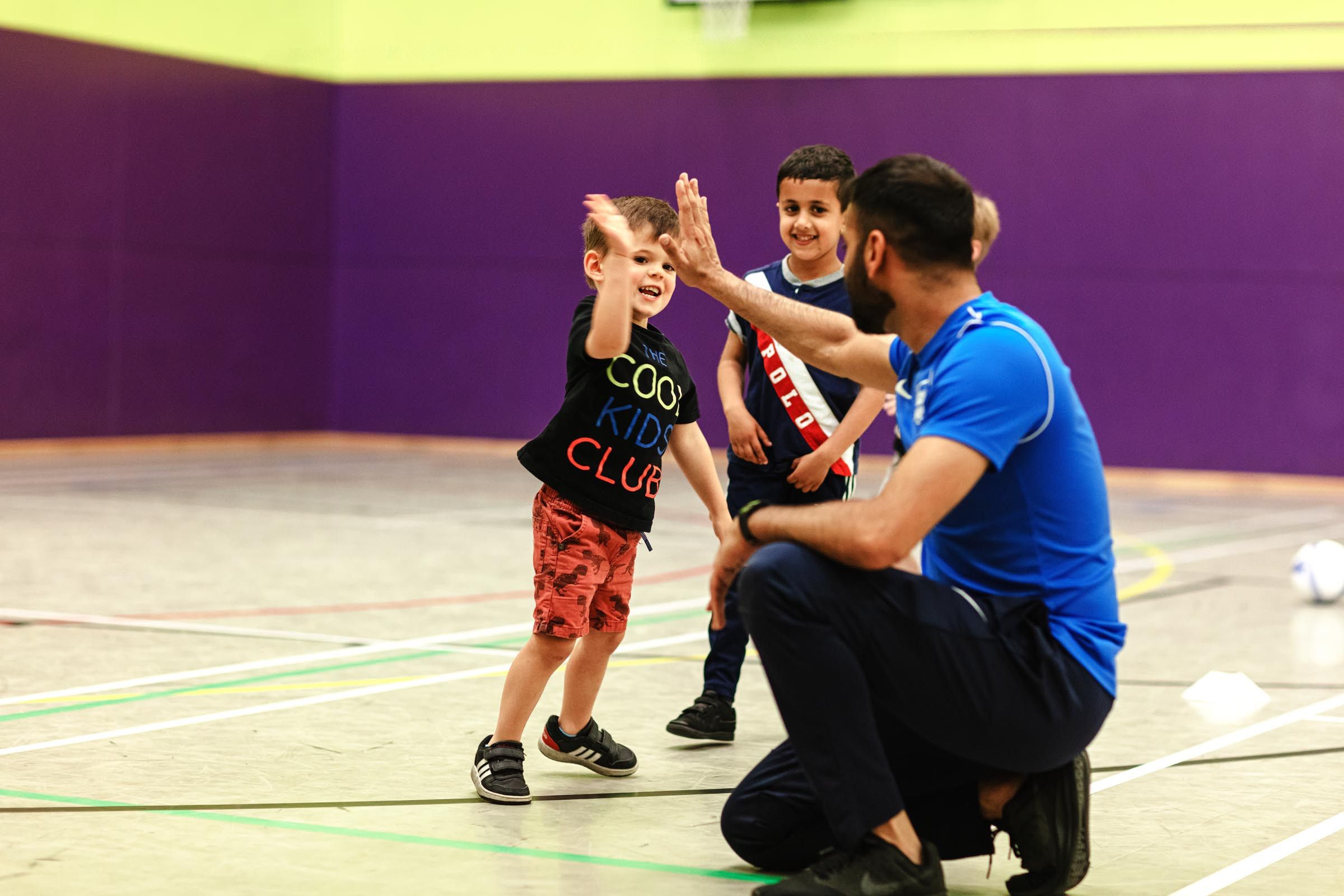 young sports group high five sports instructor